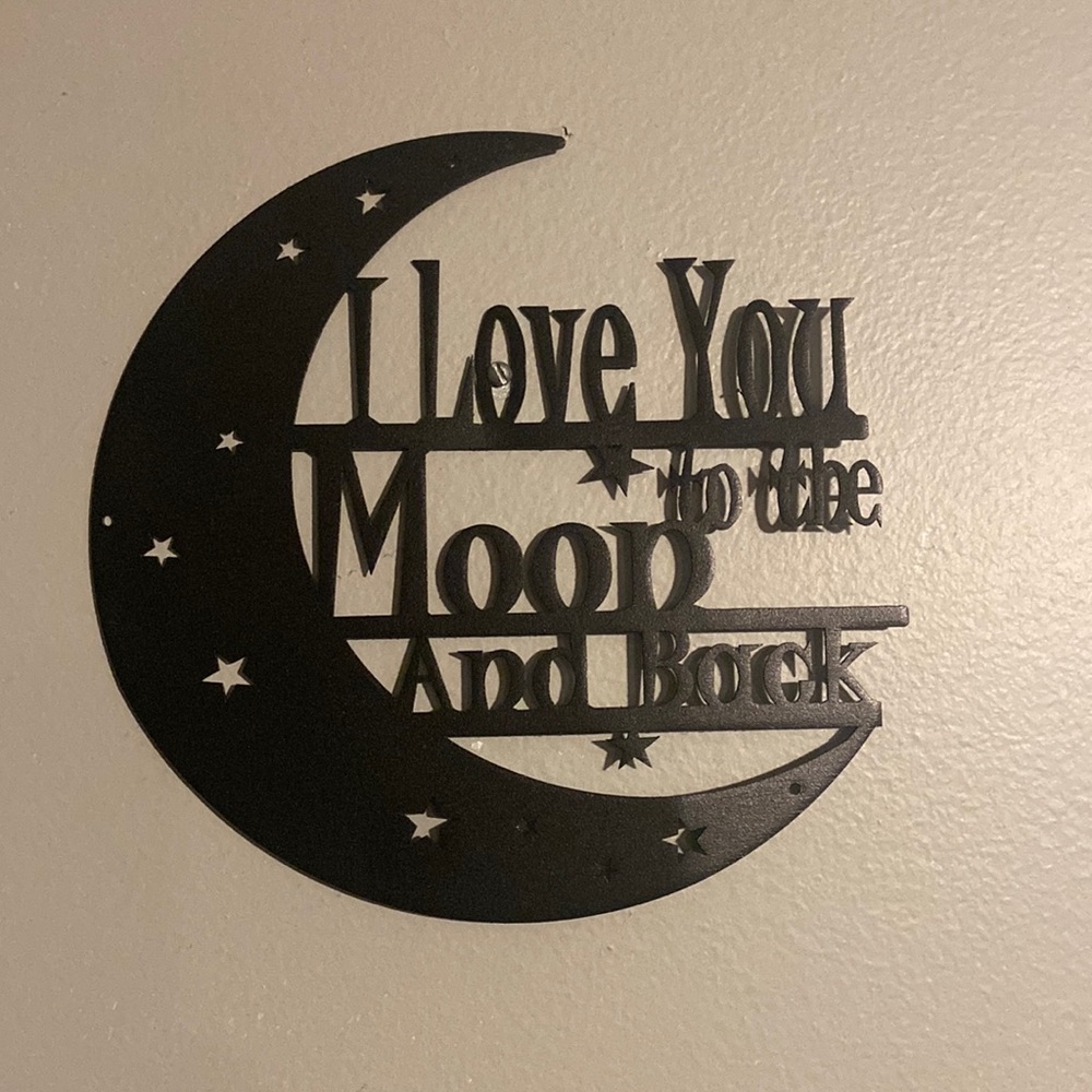 Metal “I love you to the Moon and Back” hangs on wall. 8x8